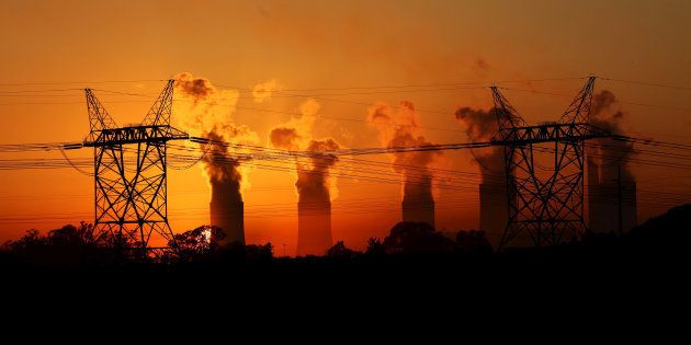 Electricity pylons are seen in front of the cooling towers at the Lethabo Thermal Power Station,an Eskom coal-burning power station near Sasolburg in the northern Free State province, March 2, 2016.