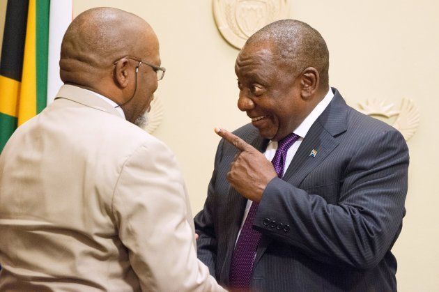 South African President Cyril Ramaphosa (R) shares a light moment with Gwede Mantashe after he was sworn in as the Minister of Mineral Resources in Parliament on February 27, 2018.