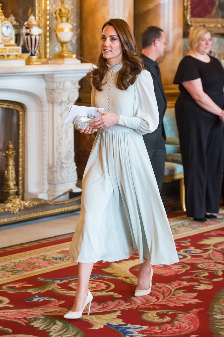 The duchess accessorized her look with a bejeweled clutch and white pumps. 