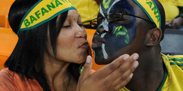 Fans kissing during a soccer match at Soccer City.