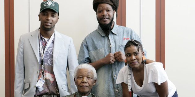 46664 artists, members of Bongo Maffin, Tshepo Seate (aka Stoan), Adrian Mupemhi (aka Appleseed) and Thandiswa Mazwai (aka Red) pose with Nelson Mandela.