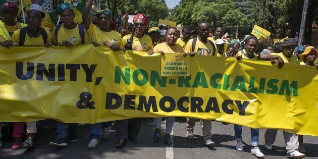 Members of African National Congress (ANC) hold banners during a protest against Racism as they march to State house which includes Presidency office from Burgers park in Pretoria, South Africa on February 19, 2016.
