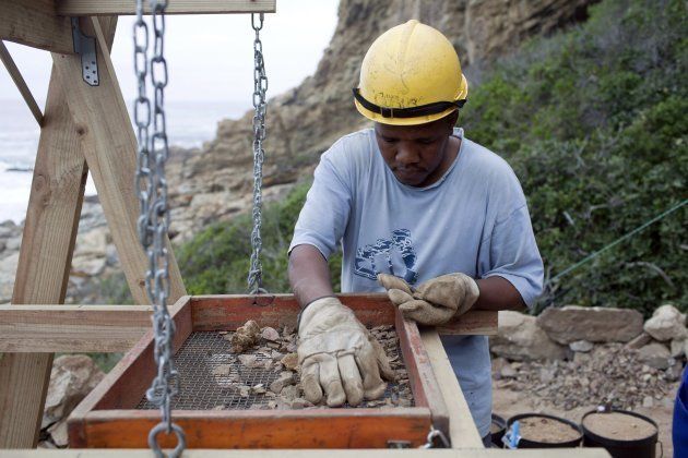 An unidentified man sort gravel outside a cave called PP13B on May 26, 2010, at Pinnacle Point near Mossel Bay South Africa.