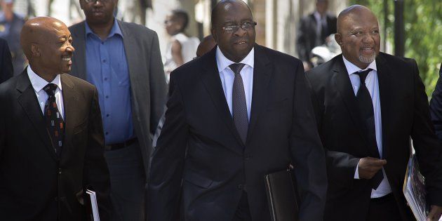 South African Minister of Finance Nhlanhla Nene walks with Commissioner of the South African Revenue Service Tom Moyane and Deputy Finance Minister Mcebisi Jonas.Photo: RODGER BOSCH/AFP/Getty Images