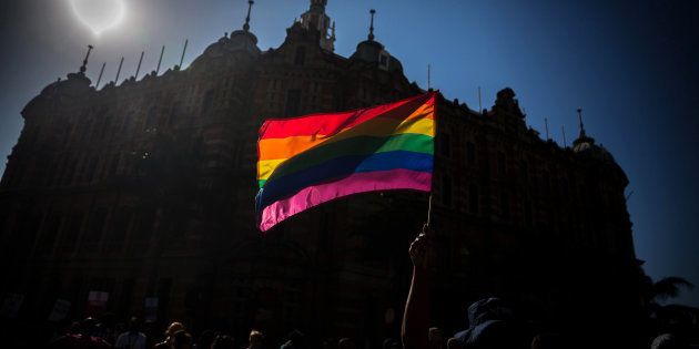 Members of the SA Lesbian, Gay, Bisexual and Transgender and Intersex (LGBTI) community wave rainbow-coloured flags at the Gay Pride Festival in Durban in June.AFP PHOTO: RAJESH JANTILAL/AFP/Getty Images