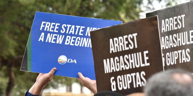 DA and EFF members demonstrate in front of the Bloemfontein Regional Court as the suspects linked to the Estina dairy farm fraud and corruption investigation appeared in court on February 15, 2018.