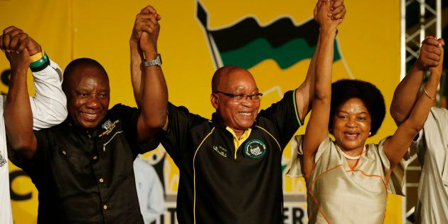 South Africa's President Jacob Zuma (2nd R) celebrates his re-election as party President alongside newly-elected party Deputy President Cyril Ramaphosa (2nd L) and re-elected Chairperson Baleka Mbete (R) at the National Conference of the ruling African National Congress (ANC) in Bloemfontein December 18, 2012.
