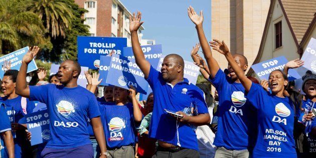 South African main opposition party Democratic Alliance supporters of mayoral candidate for Nelson Mandela Bay municipality, Athol Trollip (not in picture), cheer during a rally outside the Mayor's office on April 14, 2016 in Port Elizabeth.