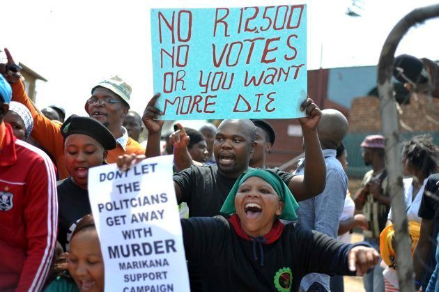 Miners from Marikana, their families and supporters march to the Union Buildings in Pretoria, to protest against the government's lack of funding for the Marikana commission of inquiry September 12, 2013.