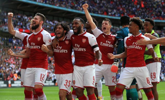 Arsenal's Olivier Giroud (left) celebrates after scoring the winning penalty to win the Community Shield at Wembley, London.