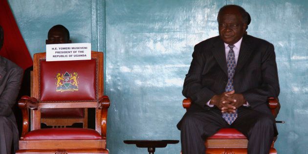 Former president Mwai Kibaki sits on the presidential chair during a Cabinet swearing-in ceremony in Nairobi in April 2008.