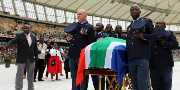 Police officers carry the casket of South African national soccer captain and goalkeeper Senzo Meyiwa at his funeral service in Durban on November 1 2014.
