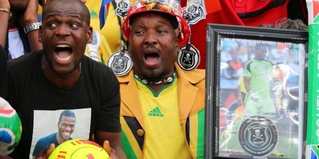 South African supporters hold a portrait of murdered Bafana Bafana captain and goalkeeper Senzo Meyiwa during the Africa Cup of Nations 2015 qualifying football match.Photo: ANESH DEBIKY/AFP/Getty Images