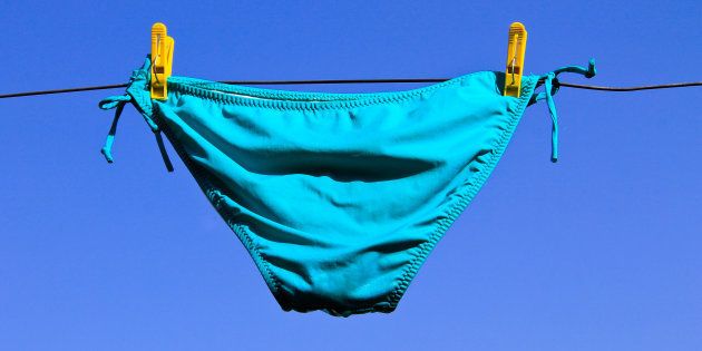 Drying woman swimsuit against blue sky