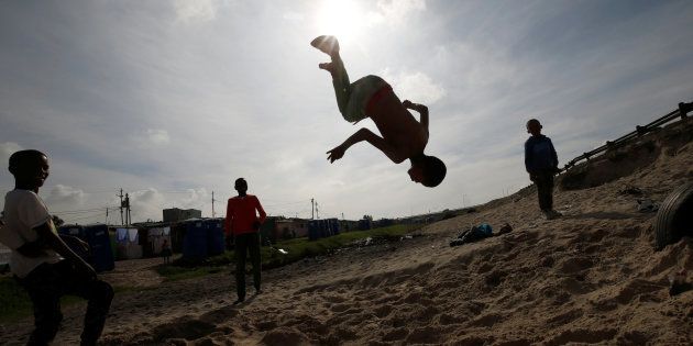Youths somersault in Khayelitsha township, near Cape Town.