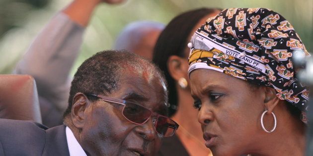 Zimbabwe's President Robert Mugabe talks to his wife Grace.