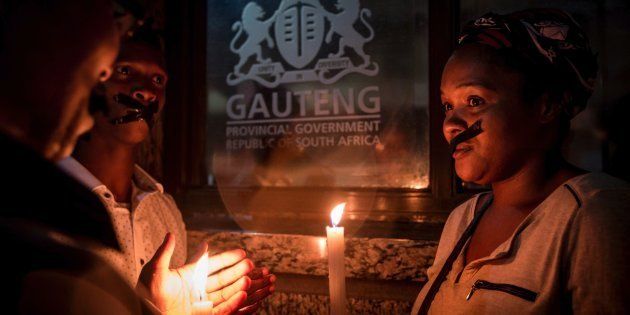 Relatives and family members of some of the 94 mentally ill patients who died last year, hold a candle light vigil organised by the Democratic Alliance in February.Photo: GULSHAN KHAN/AFP/Getty Images