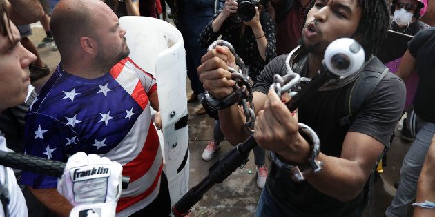 White nationalists, neo-Nazis and members of the 'alt-right' exchange insluts with counter-protesters as they attempt to guard the entrance to Emancipation Park during the Unite the Right rally August 12, 2017 in Charlottesville, Virginia.