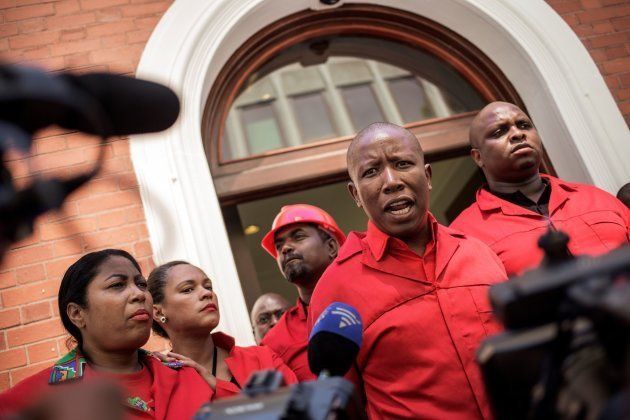 South African opposition party Economic Freedom Fighters (EFF) leader Julius Malema (2R) talks to the press after staging a walk out during the election by the Members of Parliament of the new South African President on February 15, 2018 in Cape Town.