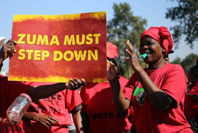 Anti-Zuma protesters and members of South Africa's ultra-left Economic Freedom Fighters party (EFF), hold a placard ahead of the vote of no confidence against President Jacob Zuma, in Pretoria, South Africa August 8, 2017. REUTERS/Siphiwe Sibeko