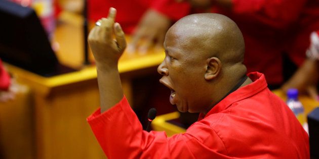 Julius Malema, leader of the Economic Freedom Fighters (EFF), raises objections before being evicted from Parliament during President Jacob Zuma's question and answer session in Cape Town.