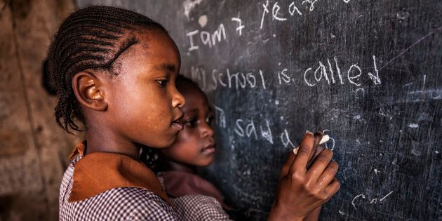 African little girls during their English class in orphanage. There is no light and electricity inside the classroom. Around 50-60 orphans live in this orphanage which is located near Nairobi.