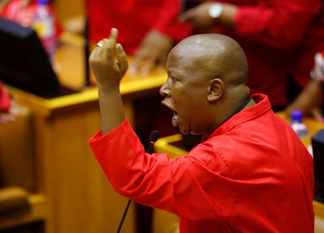 Julius Malema, leader of the Economic Freedom Fighters (EFF) party, raises objections before being evicted from Parliament during President Jacob Zuma's question and answer session in Cape Town, South Africa, May 17, 2016. REUTERS/Mike Hutchings