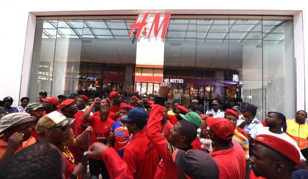 Economic Freedom Fighters (EFF) members protest against the H&M store in the Mall of Africa on January 15, 2018 in Johannesburg, South Africa. EFF members vandalised various H&M stores after an advert with an African boy wearing a sweatshirt with Coolest Monkey in the Jungle written on it sparked racist complaints. (Photo by Felix Dlangamandla/Foto24/Gallo Images/Getty Images)