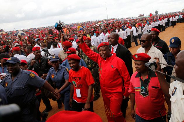 Party leader Julius Malema waves to Economic Freedom Fighters (EFF) supporters at the launch of EFF's election manifesto in Tembisa township, east of Johannesburg, February 22, 2014. South Africa goes to the polls on May 7. REUTERS/Mike Hutchings (SOUTH AFRICA - Tags: POLITICS ELECTIONS)