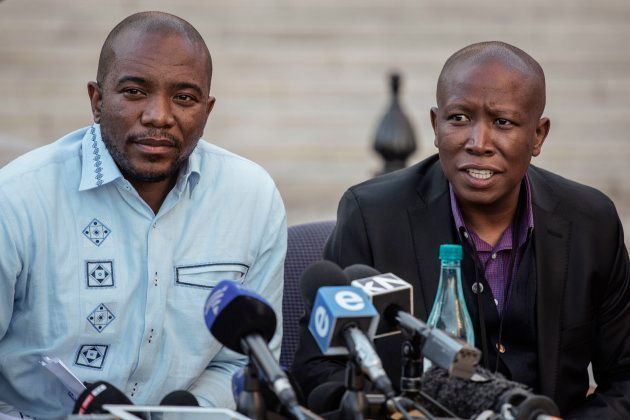 South African opposition Parties leaders Julius Malema (R) for the Economic Freedom Fighters and Mmusi Maimane (L) for the Democratic Alliance give a press conference on August 7, 2017 at the South African Parliament in Cape Town. (Photo credit should read GIANLUIGI GUERCIA/AFP/Getty Images)