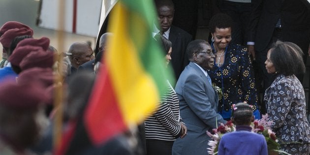 Zimbabwe's President Robert Mugabe (3rd R) and his wife Grace (2nd R) are greeted by South African Minister of International Relations and Cooperation Maite Nkoana-Mashabane (R) upon their arrival at the Waterkloof Air Force base in Pretoria on April 7, 2015, for an official state visit.