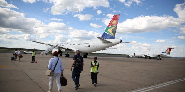 Passengers board a South African Airways aircraft.