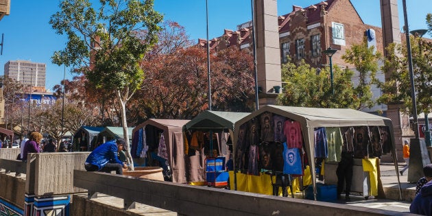 Vendors sell goods from gazebo covered stalls at a street market in the Central Business District [CBD] in Pretoria, South Africa.