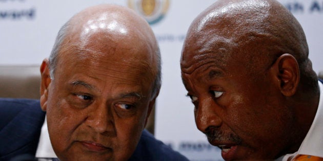 Former Finance Minister Pravin Gordhan (L) chats with Lesetja Kganyago, Governor of the Reserve Bank of South Africa, during a media briefing.REUTERS/Siphiwe Sibeko