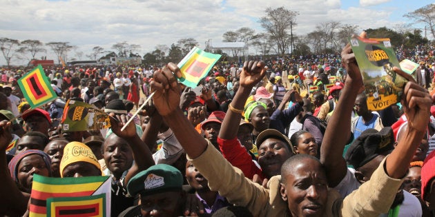 Supporters of President Robert Mugabe cheer at a rally of his ruling ZANU (PF) in Chinhoyi, Zimbabwe, July 29, 2017. REUTERS/Philimon Bulawayo