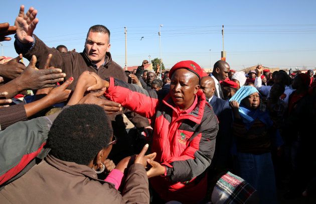 Julius Malema (R), the firebrand leader of South Africa's Economic Freedom Fighters (EFF) greets his supporters during his campaign ahead of the August 3 local elections, in Etwatwa, a township near Benoni, South Africa July 27, 2016. REUTERS/Siphiwe Sibeko