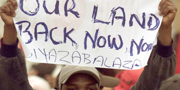 Demonstrators demand land during a march outside the opening session of the World Conference Against Racism in Durban, on August 31, 2001.