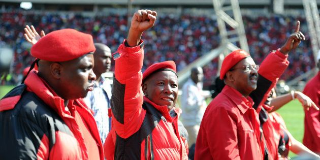 Economic Freedom Fighters (EFF) leaders Julius Malema, Dali Mpofu and Floyd Shivambu greet supporters during the party's final local government election rally at the Peter Mokaba Stadium on July 31, 2016 in Polokwane.