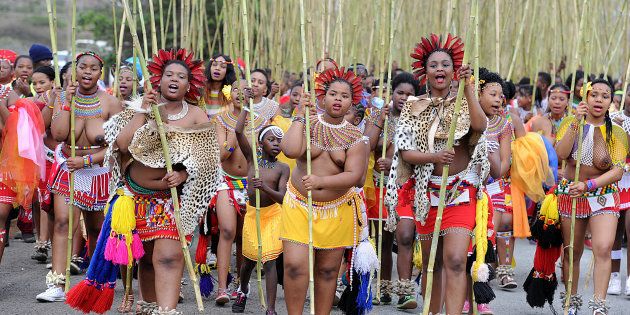 KWANONGOMA, SOUTH AFRICA SEPTEMBER 6: Maidens carrying reeds during the the annual reed dance at eNyokeni Royal Palace on September 6, 2015 in KwaNongoma, South Africa. The reed dance is a colourful and cultural celebration that promotes respect for young women, and preserves the custom of keeping girls as virgins until marriage.