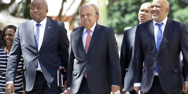 All the minster's men . . . Pravin Gordhan, Minister of Finance, with his Director-General, Fuzile Lungisa (left) and Deputy, Mcebisi Jonas (right), before delivering the mini-budget speech to Parliament in October.