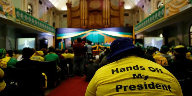 Supporters of South African President Jacob Zuma listen as he speaks at the City Hall in Pietermaritzburg, South Africa, November 18, 2016. REUTERS/Rogan Ward