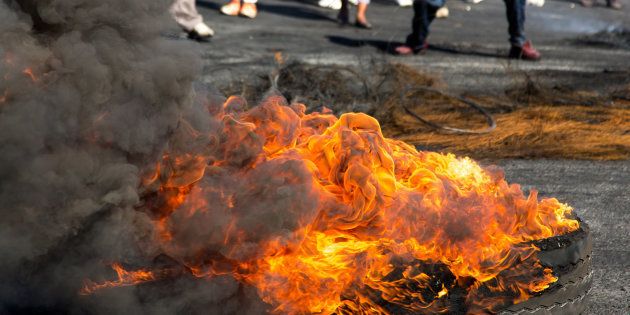 Protesters against the government burning rubber tyres in the streets in South Africa.