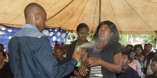 Photographs on Mount Zion General Assembly's Facebook page show Lethebo Rabalago spraying the insecticide in people's faces.
