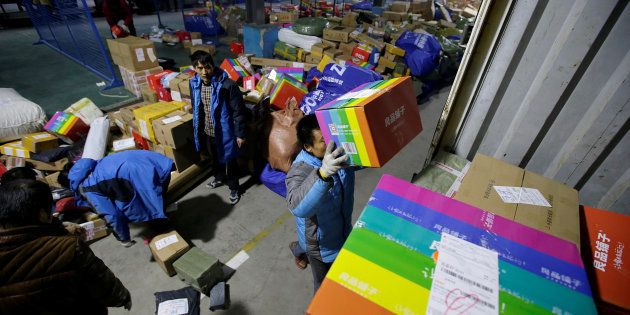 Workers move parcels at a logistic centre of ZTO Express during the Alibaba 11.11 global shopping festival, in Beijing, China November 11, 2016.