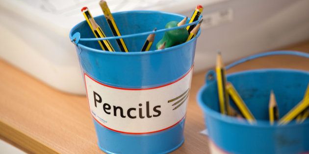 Pots of coloured pencils in a UK primary school classroom