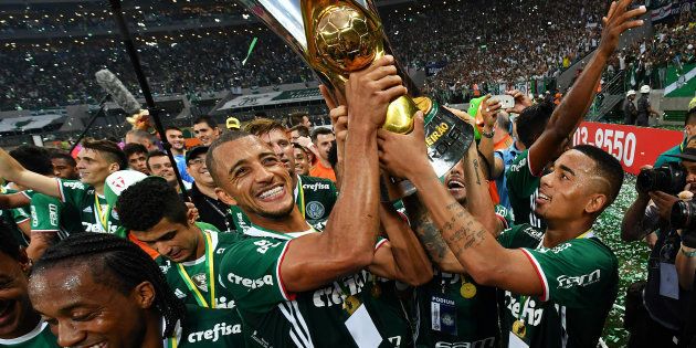 Palmeiras player Gabriel Jesus (right) holds up the trophy as he celebrates with teammates after winning the Brazilian championship football final match against Chapecoense and becoming champions at Allianz Parque stadium in Sao Paulo Brazil on 27 November 2016.