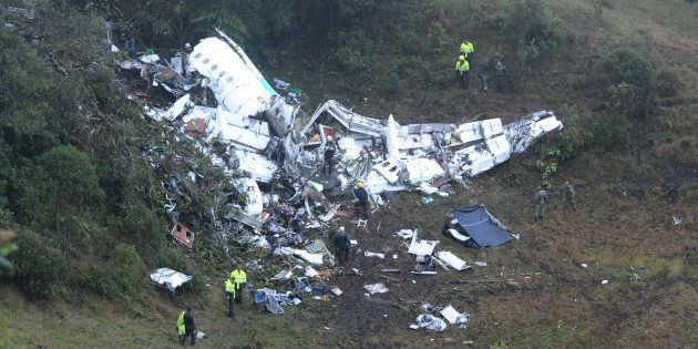 Police officers and rescue workers search for survivors around the wreckage of a chartered airplane that crashed in La Union, a mountainous area outside Medellin, Colombia on 30 November 2016.