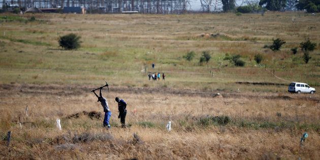 A man is seen digging to mark out vacant land in Olievenhoutbosch near Centurion in March 2018.