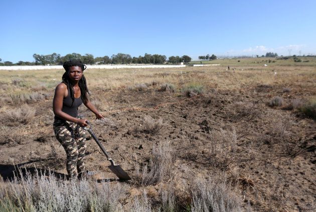 Noluthando Mswane gestures as she uses a spade to mark vacant land in Olievenhoutbosch. March 12, 2018.