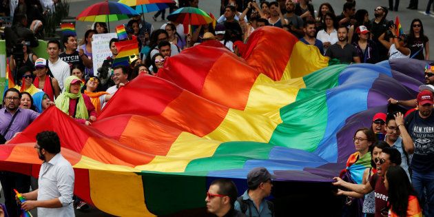 The LGBTI community wave a rainbow flag during a march in support of gay marriage, sexual and gender diversity in Mexico City, Mexico September 11, 2016. REUTERS/Carlos Jasso